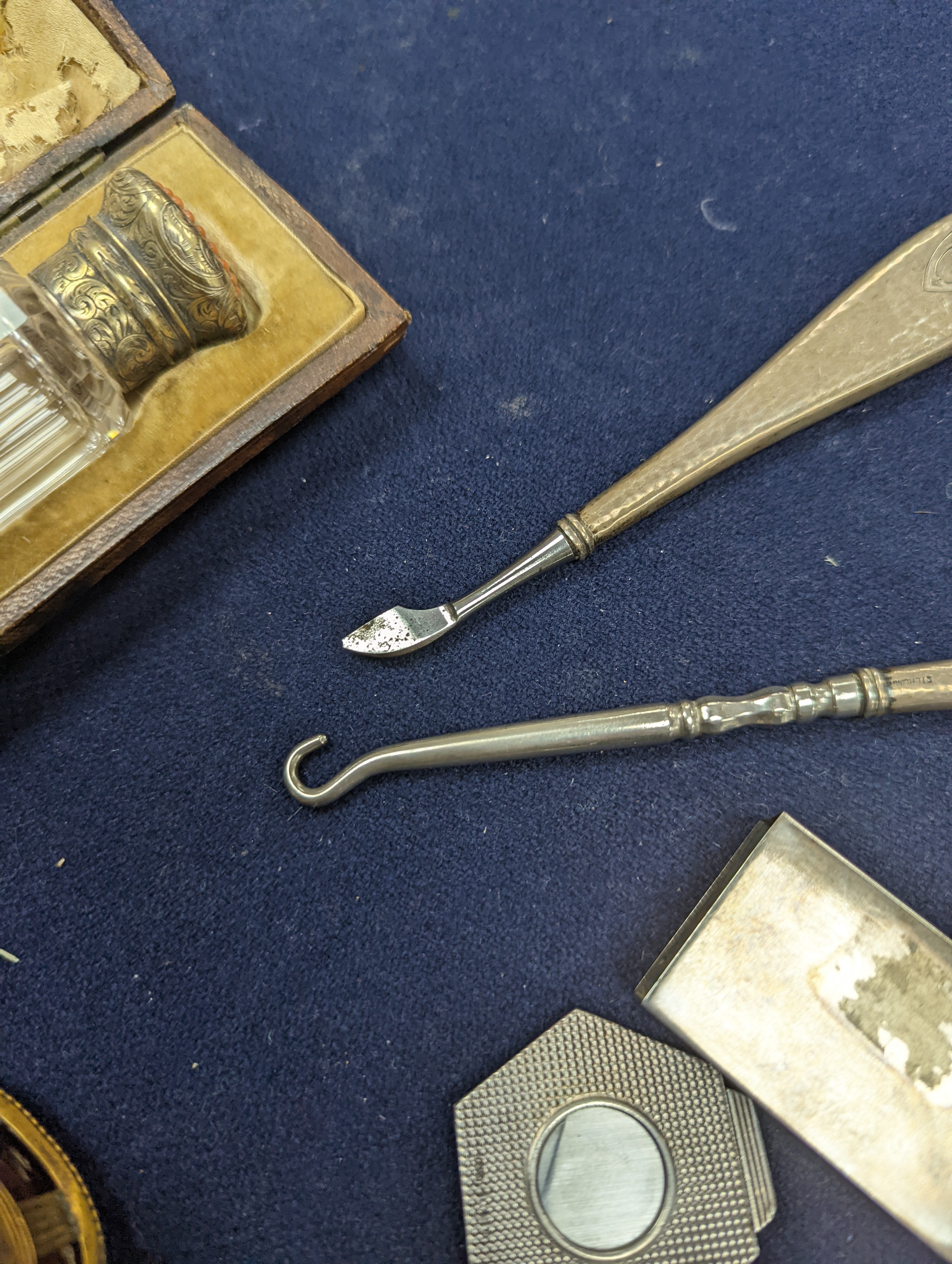 A cased Victorian engraved gilt white metal and coral set double ended scent bottle, 13.4cm, a silver cigar cutter, a belt, a silver buckle, gilt and cranberry perfume bottle, etc.